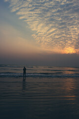 Fototapeta premium silhouette of a person on the beach at sunset 