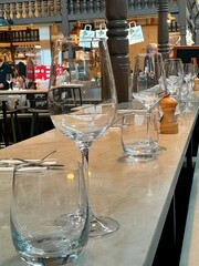 Wine glasses and water glasses in a restaurant bar in Stockholm. The glasses are neatly placed, awaiting lunch guests in a sales hall in Stockholm, Sweden.