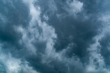Dark sky covered with rain storm clouds background. Dramatic sky with dark storm clouds in rainy season.