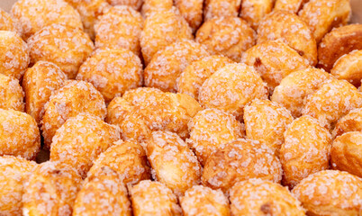 Puff pastries, round sugar-coated sugar puffs, golden crispy baked sweets, traditional French patisserie, biscuits