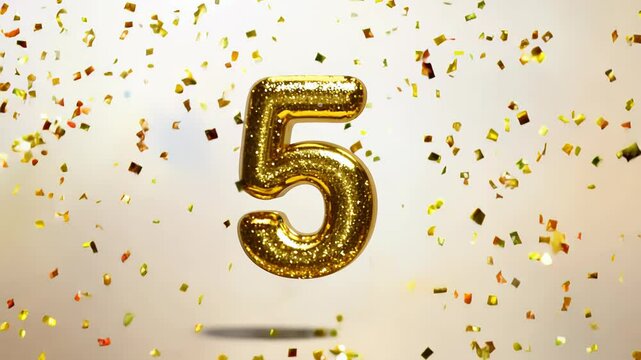 Golden number 5 on a light background surrounded by confetti and sparkles