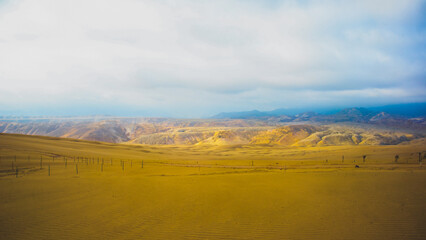desertic landscape with cloudy sky in the afternoon