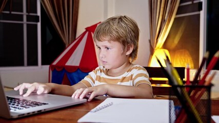 Preschool Boy Learning Online with Laptop, Engaging in Early Education at Home