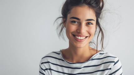 Naklejka premium Casual Portrait of a Cheerful Young Woman in Striped Shirt