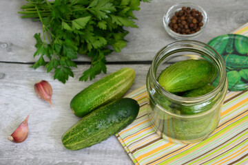 a jar of pickled cucumbers and other vegetables on a table