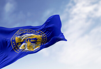 Nebraska state flag waving in the wind on a clear day