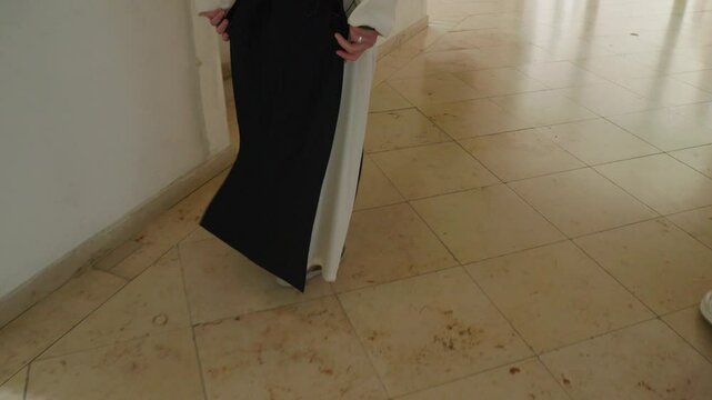 monk walking over marble floor in monastery