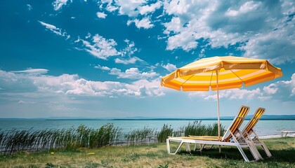 Beach chair and umbrella on the shore of Lake Balaton, Hungary