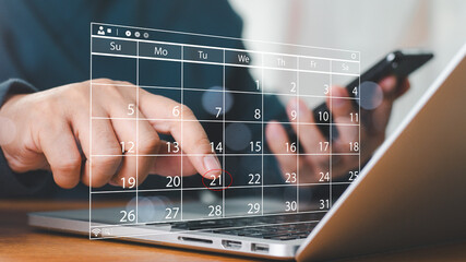 Time management concept. Businessman manages time for effective work. Calendar on the virtual screen interface. Highlight appointment reminders and meeting agenda on the calendar.