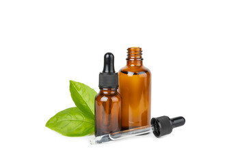 Basil essential oil isolated on white background. Basil essential oil and fresh leaves. Aromatherapy. Aroma oil. Medical herbs. Alternative medicine. Place for text. Copy space.