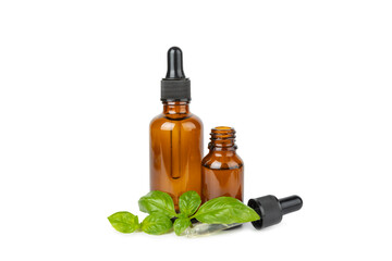 Basil essential oil isolated on white background. Basil essential oil and fresh leaves. Aromatherapy. Aroma oil. Medical herbs. Alternative medicine. Place for text. Copy space.
