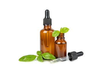 Basil essential oil isolated on white background. Basil essential oil and fresh leaves. Aromatherapy. Aroma oil. Medical herbs. Alternative medicine. Place for text. Copy space.