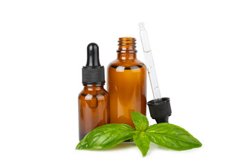 Basil essential oil isolated on white background. Basil essential oil and fresh leaves. Aromatherapy. Aroma oil. Medical herbs. Alternative medicine. Place for text. Copy space.