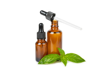 Basil essential oil isolated on white background. Basil essential oil and fresh leaves. Aromatherapy. Aroma oil. Medical herbs. Alternative medicine. Place for text. Copy space.