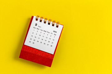 Calendar for September 2024 on a yellow background.