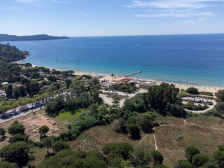 Aerial view on boats, crystal clear blue water of Plage du Debarquement white sandy beach near Cavalaire-sur-Mer and La Croix-Valmer, summer vacation on French Riviera, Var, France