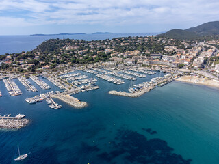 Aerial view on yacht boats, crystal clear blue water of white sandy beach near Cavalaire-sur-Mer, summer vacation on French Riviera, Var, France