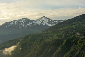 Fototapeta premium Landscape of valley with fog in the austrian village Bramberg near the mountain Wildkogel