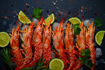 Langoustines, Australian, freshly frozen on ice, top view, lime and greens,