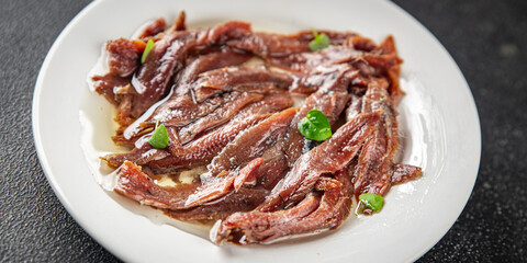 anchovies in a plate on the table canned fish in oil fresh and tasty seafood meal food snack on the table copy space food background rustic