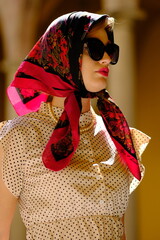 Beautiful woman with blue eyes dressed in the 1920s in the Barcelona cathedral
