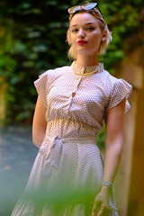 Beautiful woman with blue eyes dressed in the 1920s in the Barcelona cathedral