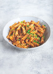 pasta in navy, pasta with minced meat, gray background, homemade, fusilli pasta, no people,