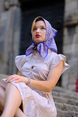 Beautiful woman with blue eyes dressed in the 1920s in the Barcelona cathedral