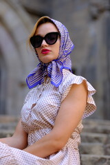 Beautiful woman with blue eyes dressed in the 1920s in the Barcelona cathedral