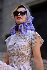 Beautiful woman with blue eyes dressed in the 1920s in the Barcelona cathedral