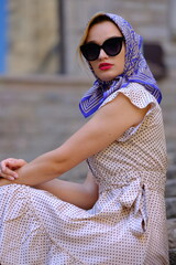 Beautiful woman with blue eyes dressed in the 1920s in the Barcelona cathedral