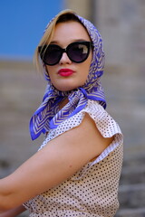 Beautiful woman with blue eyes dressed in the 1920s in the Barcelona cathedral