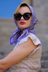 Beautiful woman with blue eyes dressed in the 1920s in the Barcelona cathedral