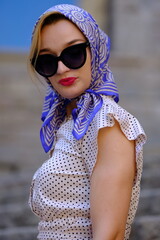 Beautiful woman with blue eyes dressed in the 1920s in the Barcelona cathedral