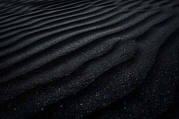 Black Sand dune. Black Sand beach macro photography. Background, texture, wave pattern of oceanic sand on the beach, black. Texture of beach sand. Black beach.