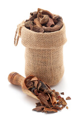 Close-up of Organic Zebrawood or Kakda Singi (Pistacia integerrima), in a jute bag and on a scoop, Isolated on a white background.