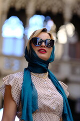 Beautiful woman with blue eyes dressed in the 1920s in the Barcelona cathedral