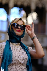 Beautiful woman with blue eyes dressed in the 1920s in the Barcelona cathedral