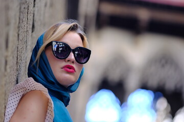 Beautiful woman with blue eyes dressed in the 1920s in the Barcelona cathedral