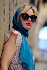 Beautiful woman with blue eyes dressed in the 1920s in the Barcelona cathedral