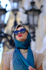 Beautiful woman with blue eyes dressed in the 1920s in the Barcelona cathedral