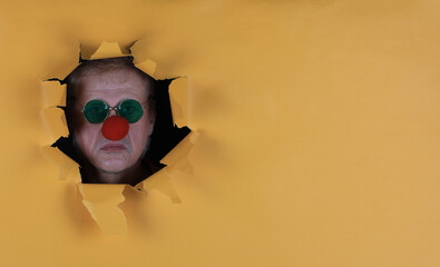 Red Nose Day, clown,man with red nose in paper hole