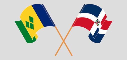 Crossed and waving flags of Saint Vincent and the Grenadines and Dominican Republic