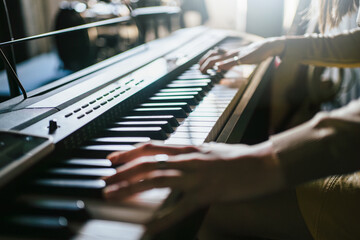 Hands Playing Keyboard in Music Studio. 