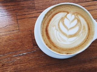 cup of coffee on wooden table at coffee shop cafe