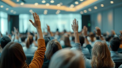 Attendees raising hands at a conference meeting in a modern room, capturing active participation and engagement.