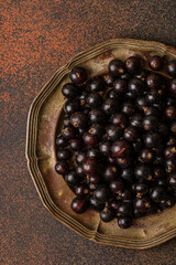 black currant berry on a metal plate