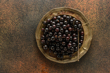 black currant berry on a metal plate