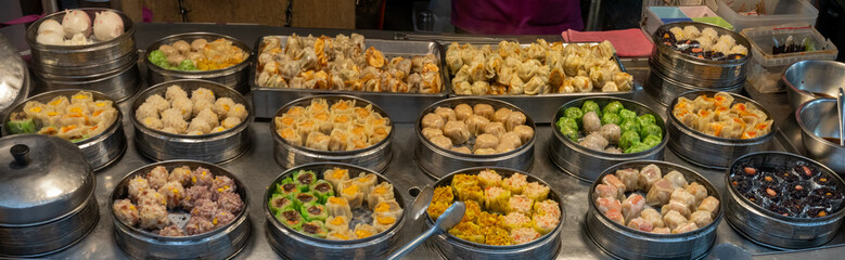 Endless variety of delicious dumplings, rolls and Xiao Long Bao on the stalls of the famous night market of Keelung, Taiwan