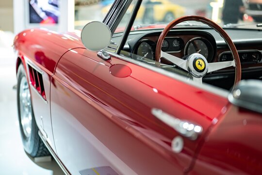 Interior and steering wheel of Ferrari 275 GTS red sports car in Museum Enzo Ferrari Modena